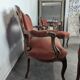Louis XV style salon in carved walnut with orange velvet, seven pieces.