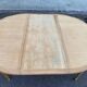 Extendable round table in renovated Louis XVI style, made of light wood, with 2 extensions.