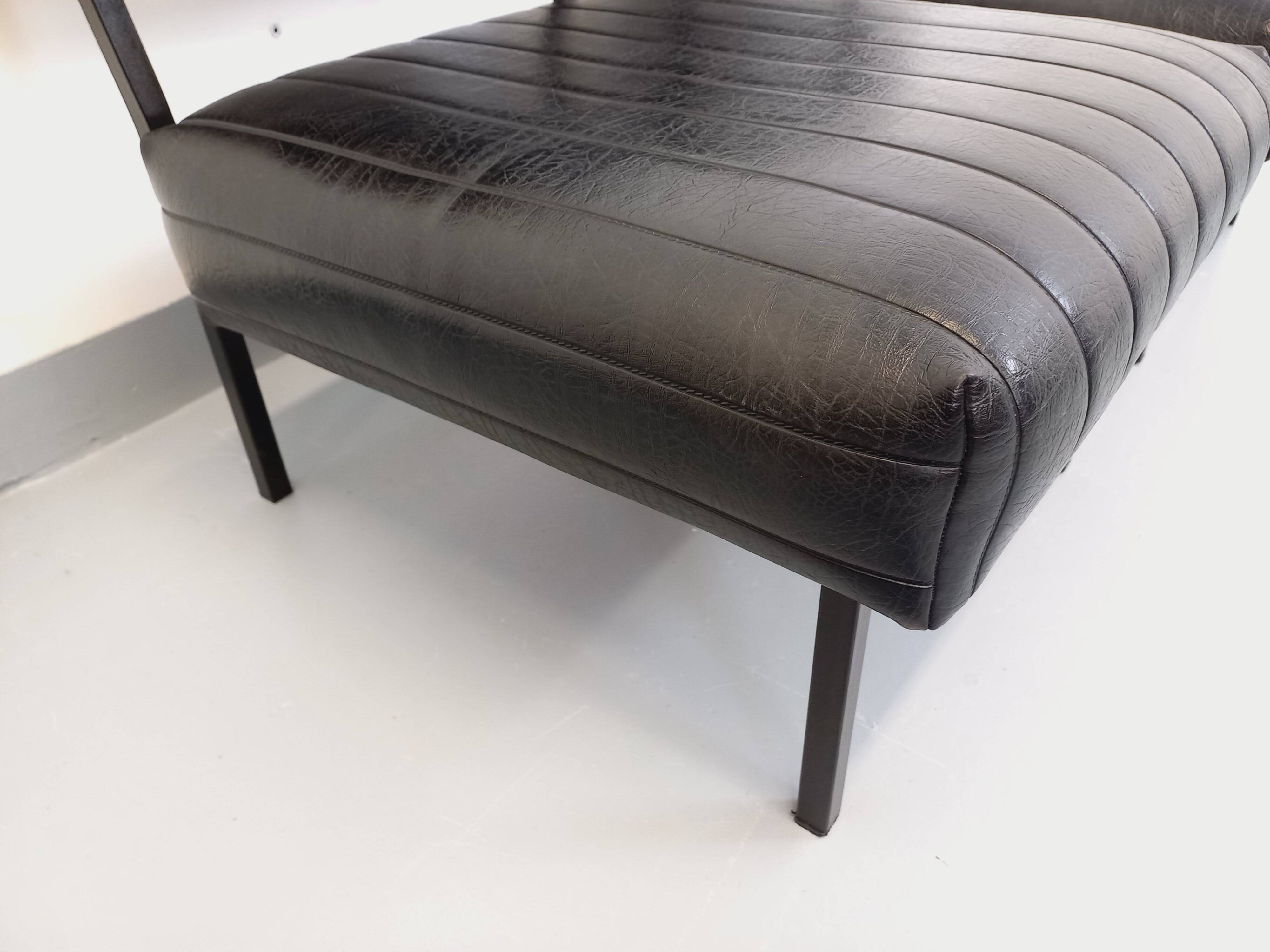 Set of 2 vintage modernist armchairs in black faux leather and metal.