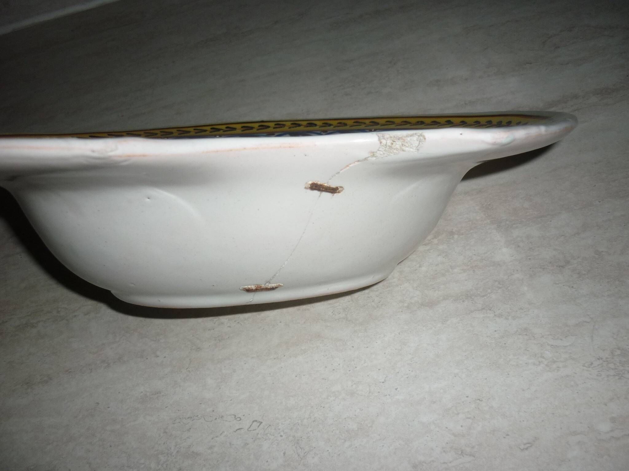 Old beard dish repair with staples