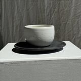 White Indonesian ceramic cup and gray saucer
