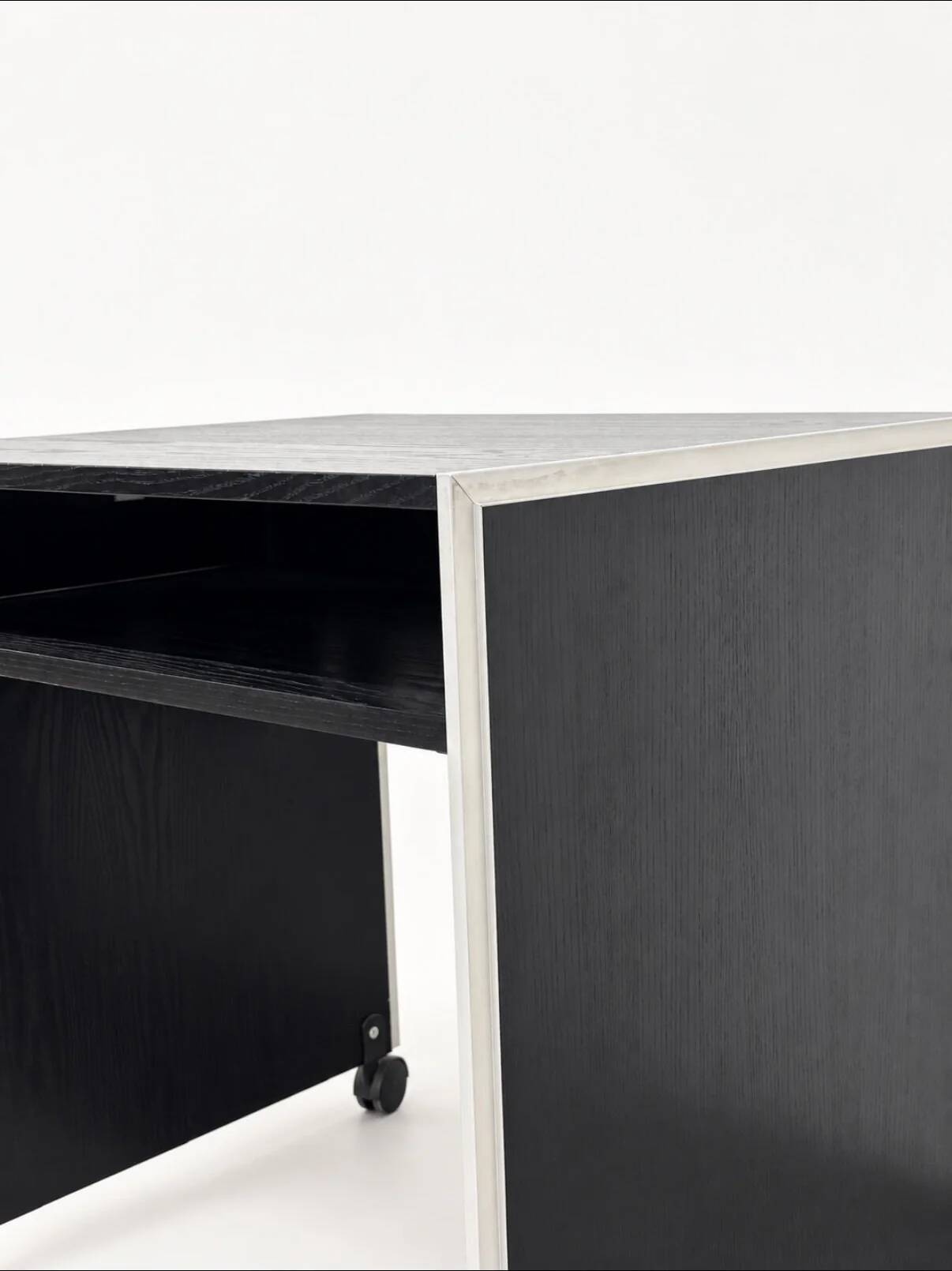 Vintage black computer desk on wheels with an aluminium edge.