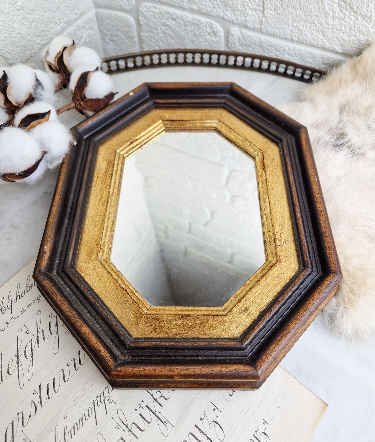 Miroir ancien en bois octogonal noir et doré