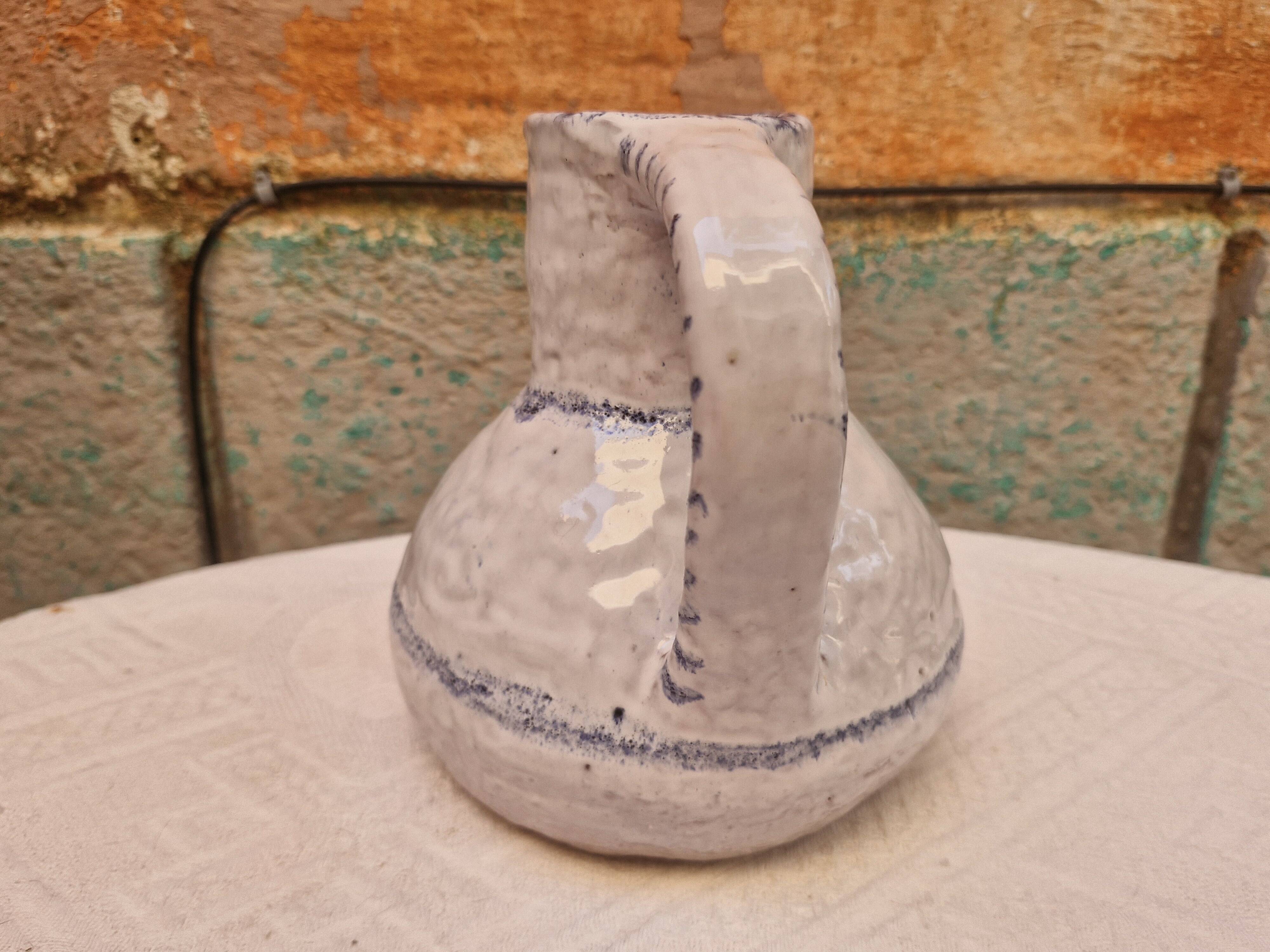 Old stamped glazed terracotta jug