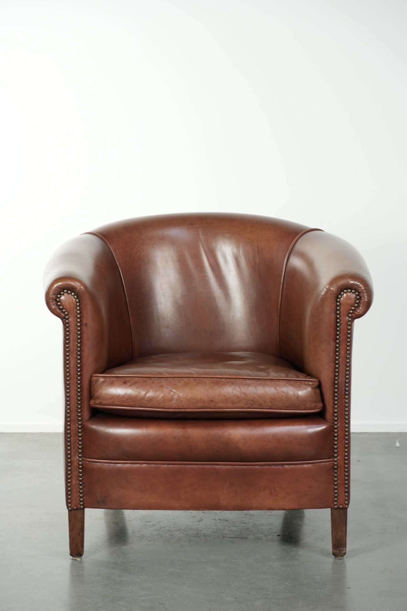 Cow leather club armchair in beautiful dark cognac colour in English style