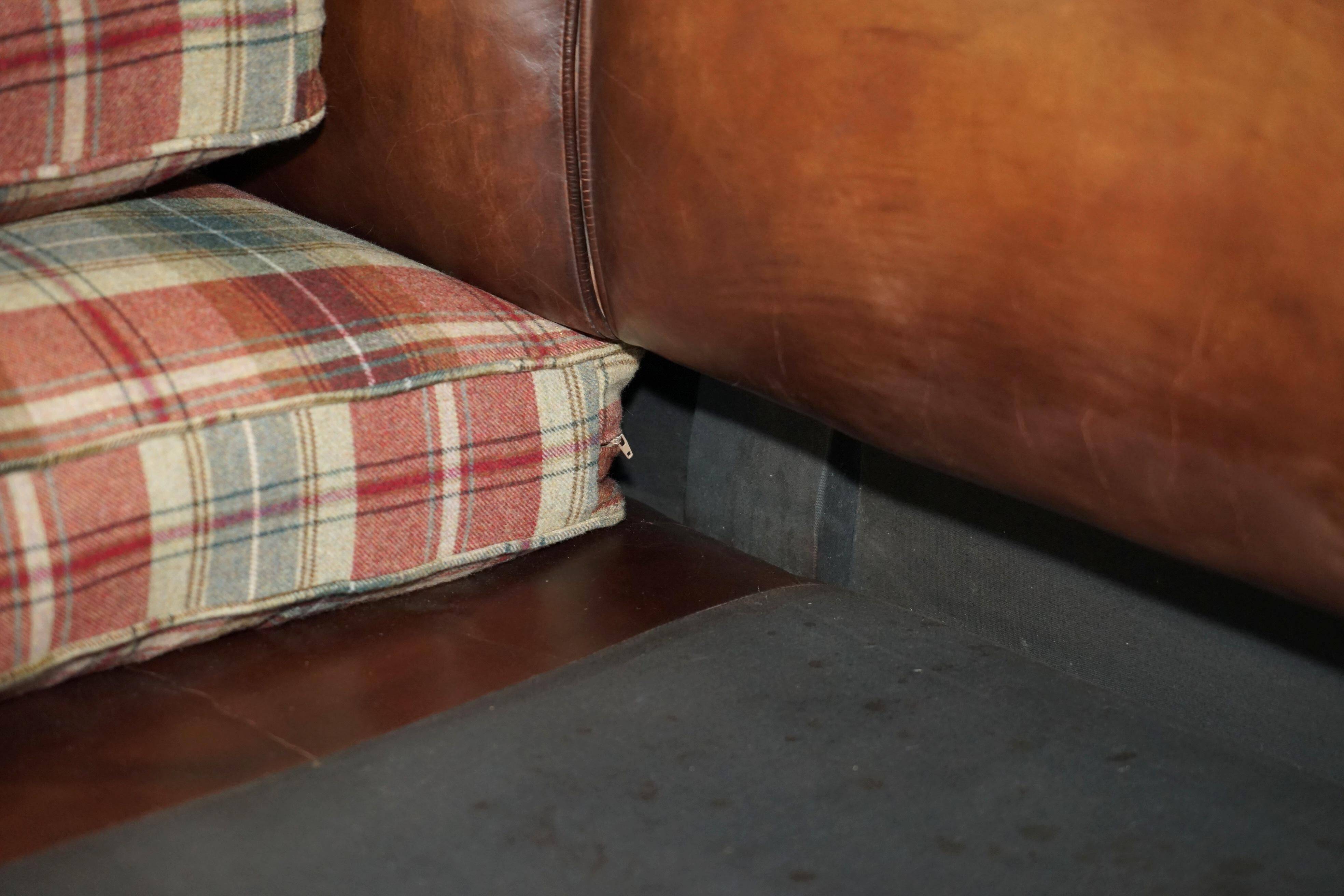 George Smith Signature Scroll leather canapé with tartan Scottish wool cushions.