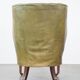 Green antique barrel back wingback chair on wheels