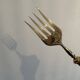 Engraved meat fork in silver and gold metal