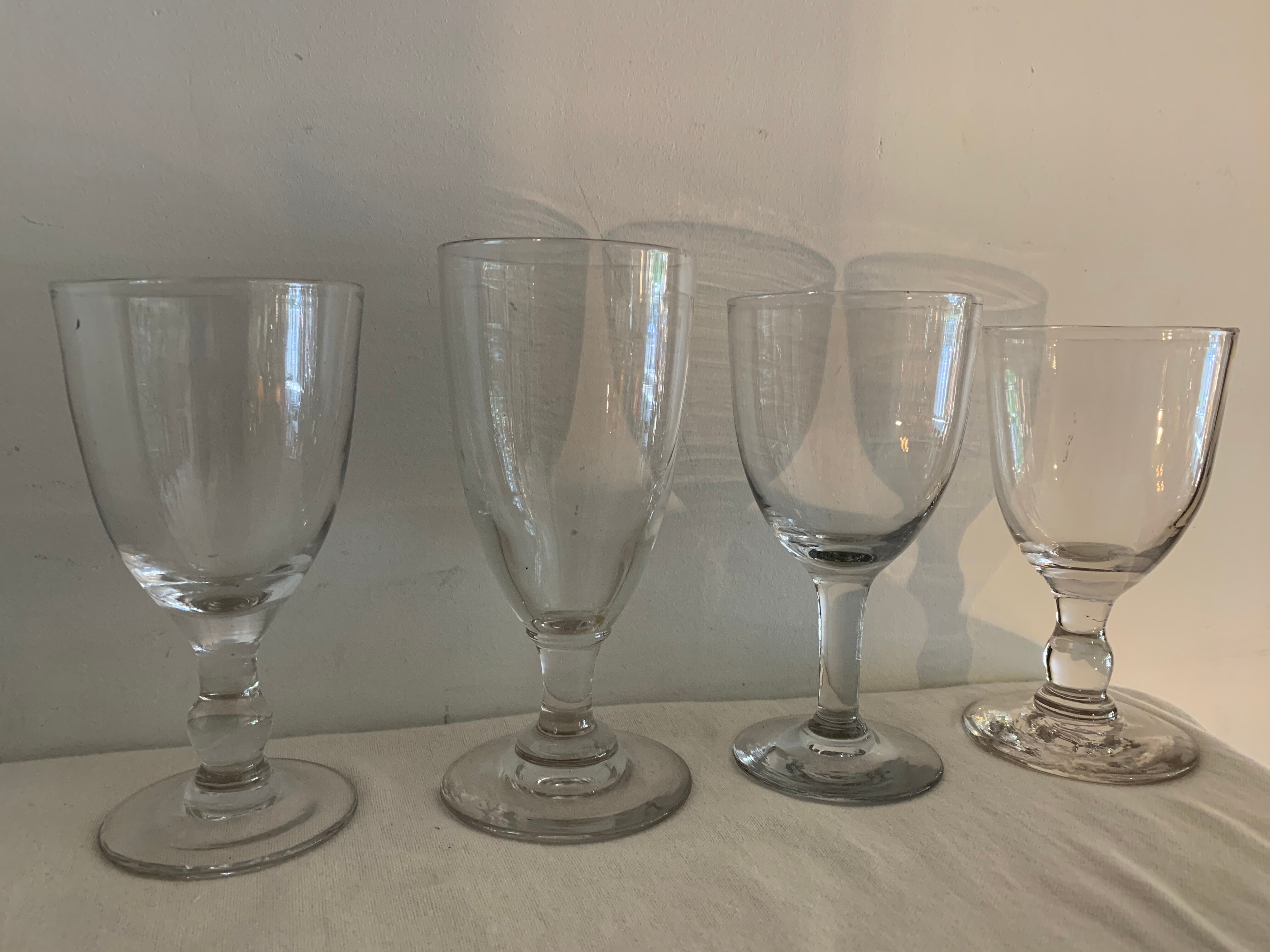 8 old blown and different foot wine glasses