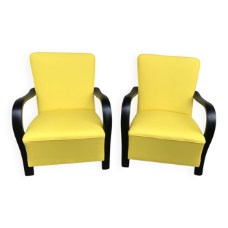 Pair of yellow Art Deco armchairs in cotton and wood, black frame, 1920s.