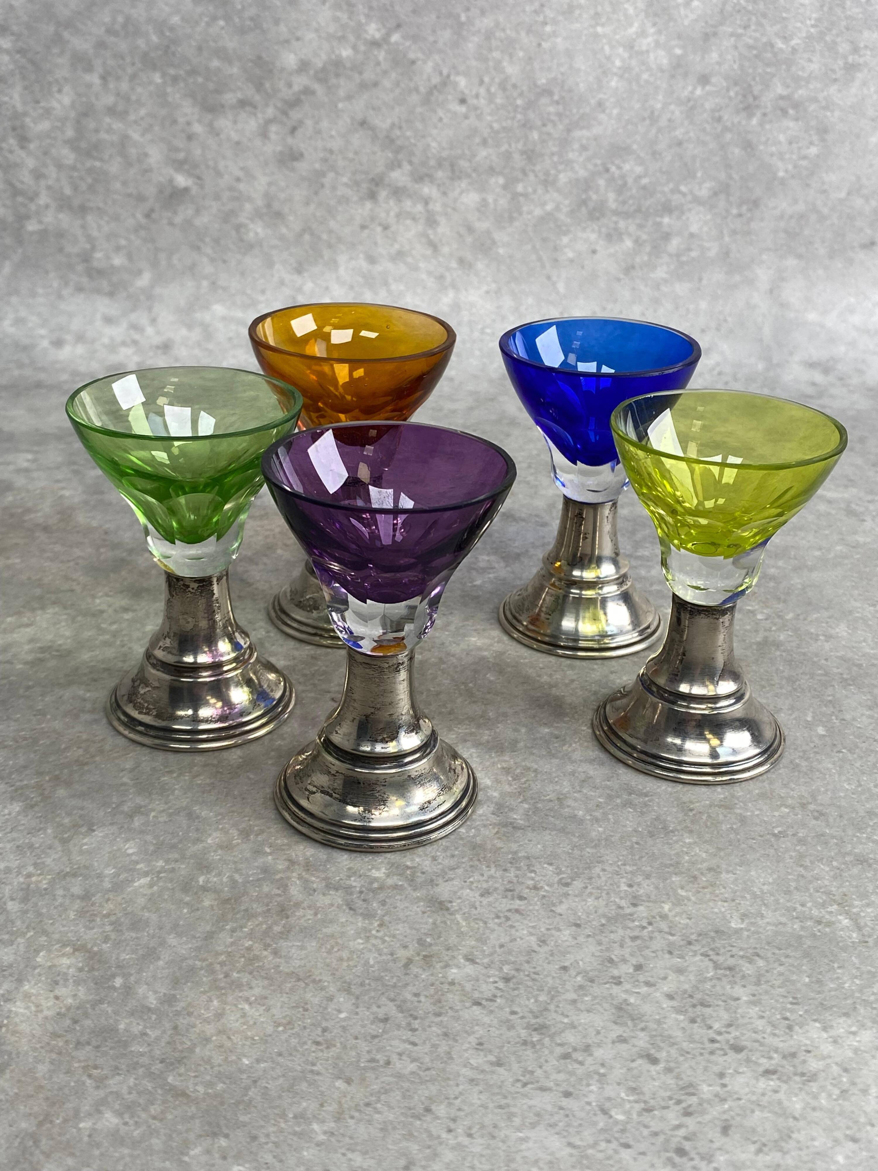 Set of 5 coloured stemmed glasses on silver stems.