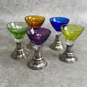 Set of 5 coloured stemmed glasses on silver stems.