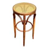Old high stool in curved wood with caned seat