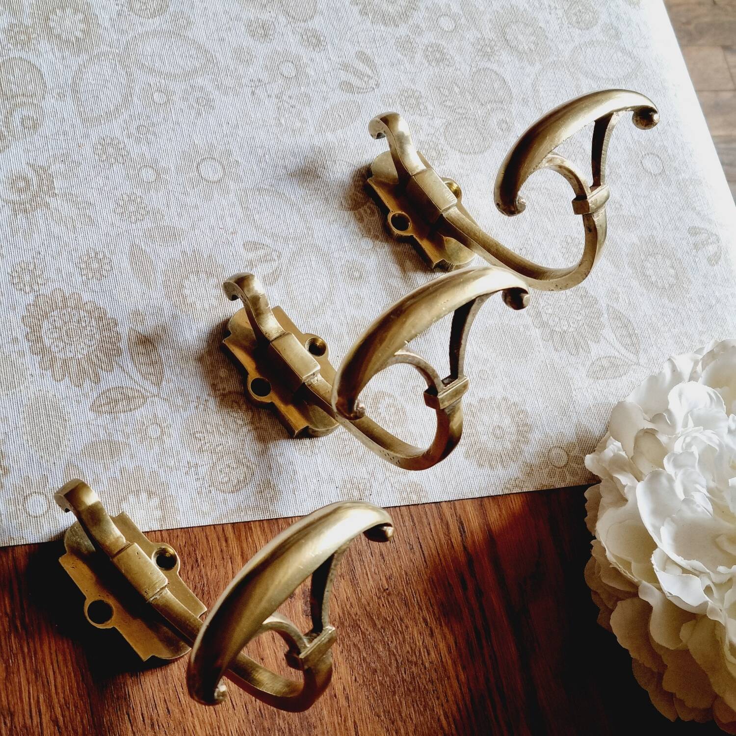 Trio of brass coat hooks or coat racks