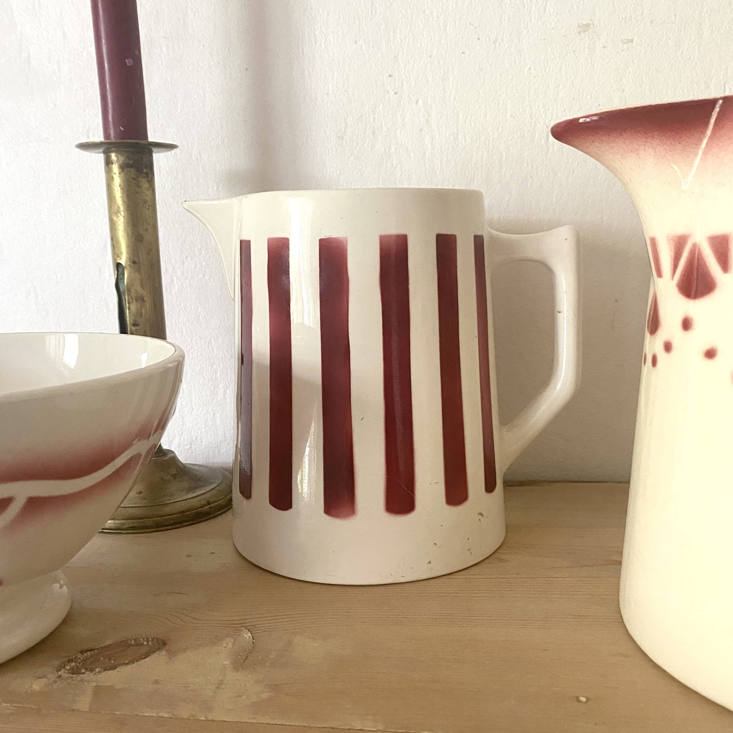 Antique earthenware pitcher with burgundy stripes