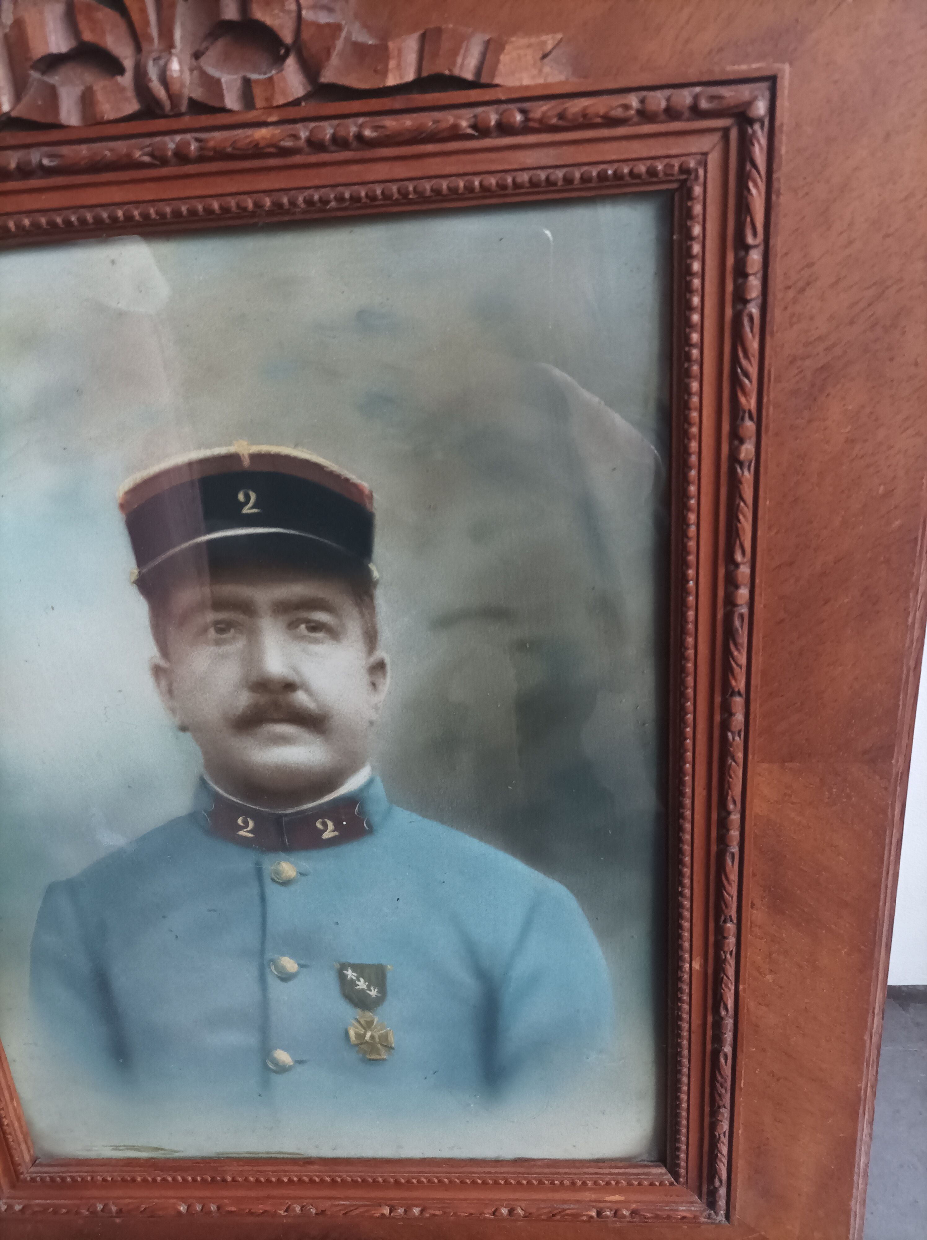 Antique wooden frame with carved portrait knot