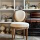 Medallion back chair in moulded wood and beige fabric.
