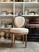 Medallion back chair in moulded wood and beige fabric.