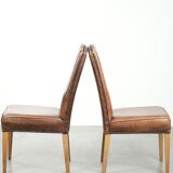 Set of 2 characterful dining chairs of sheepskin leather with a high back