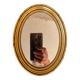 Old golden oval mirror