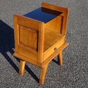 Vintage oak bedside table with tapered legs.