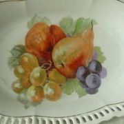 Pierced porcelain basket decorated with fruit still life.