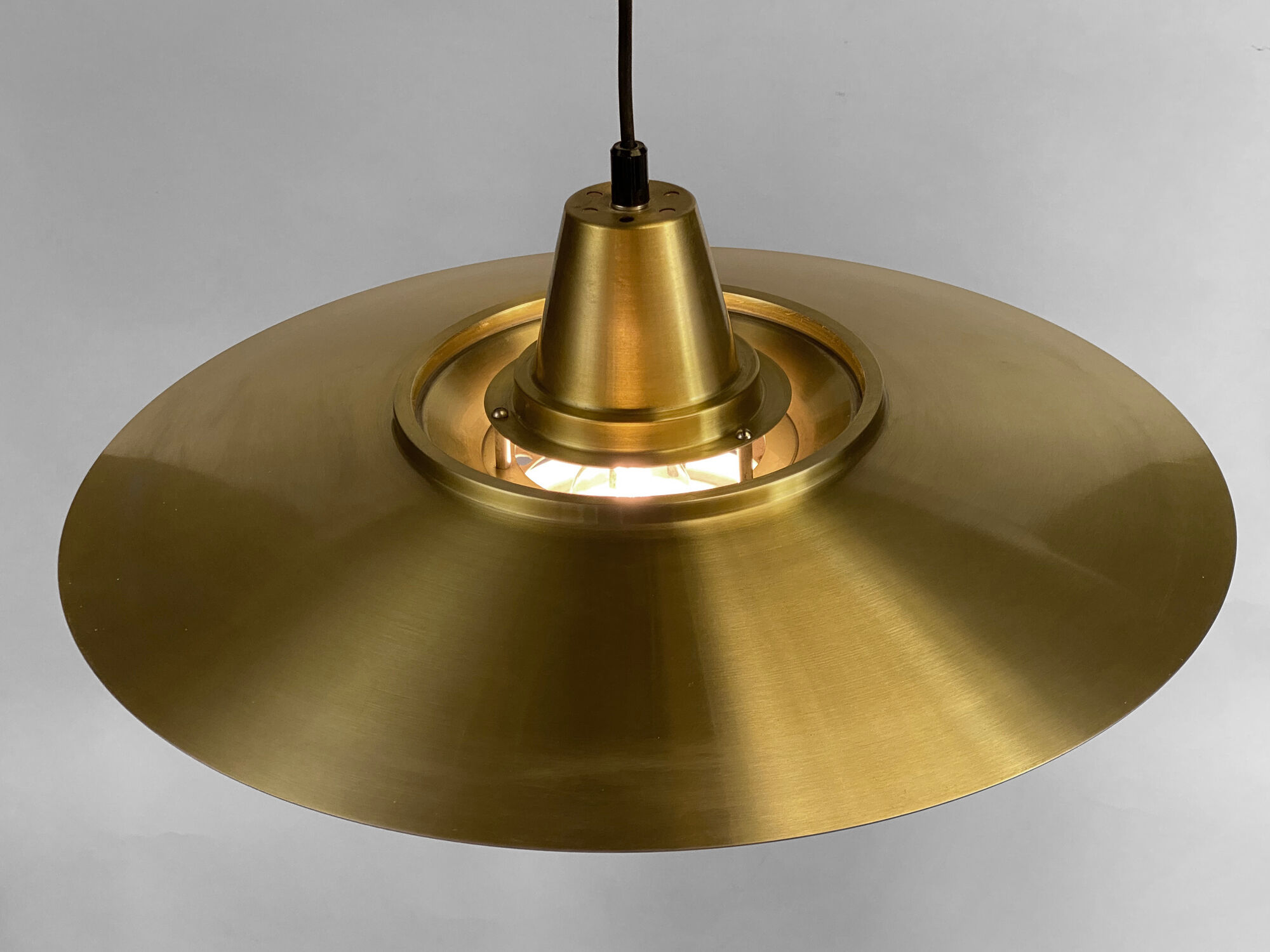 Large brushed aluminum pendant light with golden finish. Produced by Jeka. Denmark 1970s