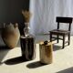 Black petrified wood side table with beige stripes and a semicircular shape.