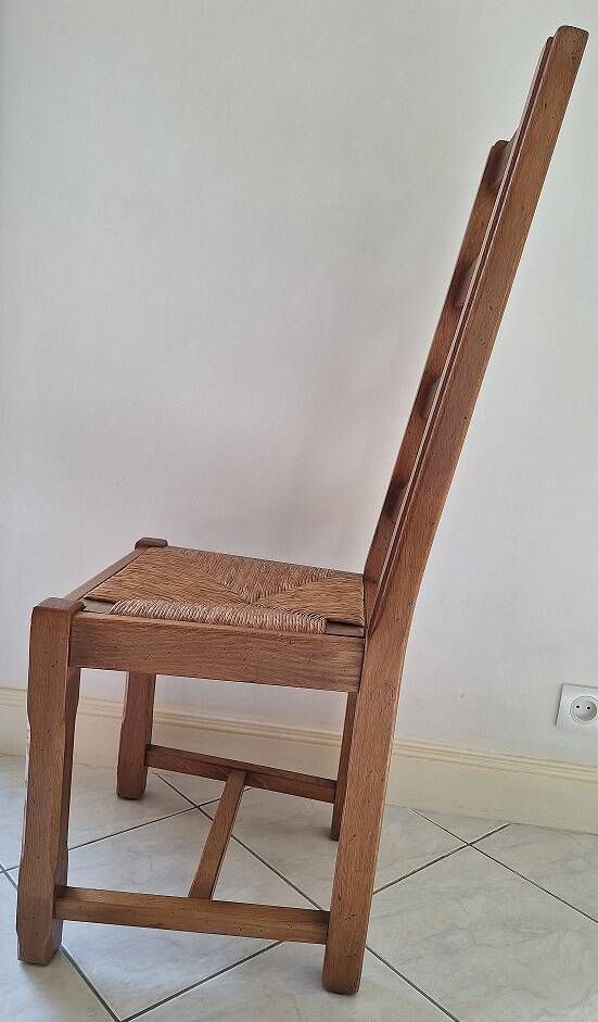 Set of 6 solid oak chairs with straw seats.