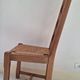 Set of 6 solid oak chairs with straw seats.