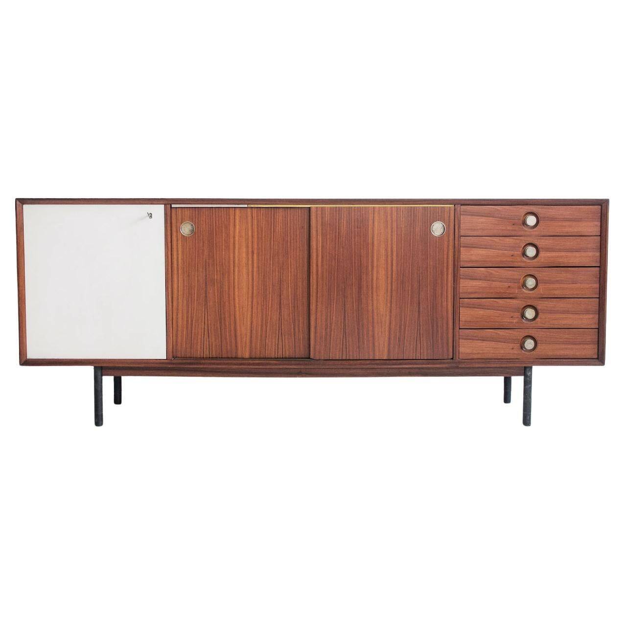 Wooden sideboard with sliding door and white drawers, around 1960.