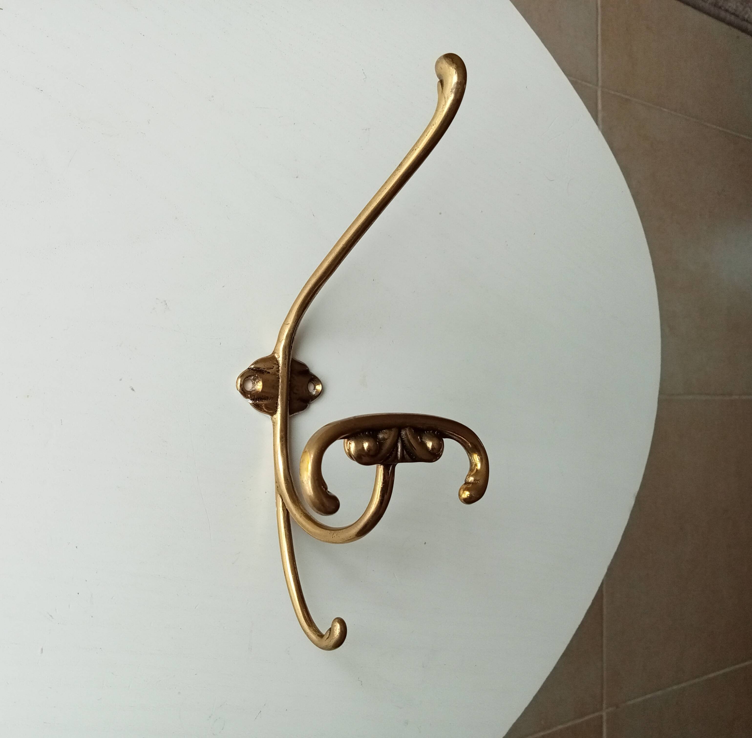 Old coat hook in solid golden brass