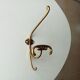 Old coat hook in solid golden brass