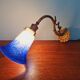 Wall light in gilded bronze and blue marmoreal glass, early 20th century