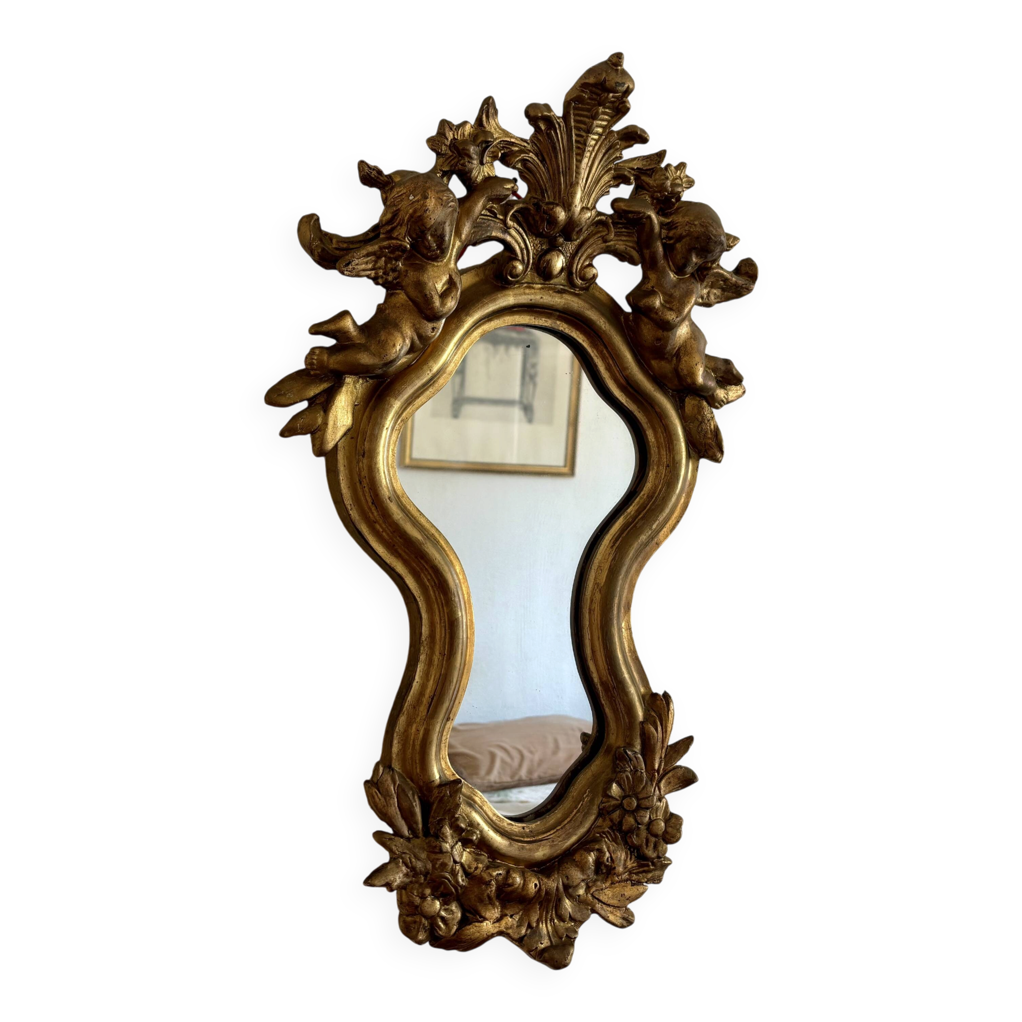 Antique rococo mirror with putti, gilded carved wood and stucco frame, 19th century.