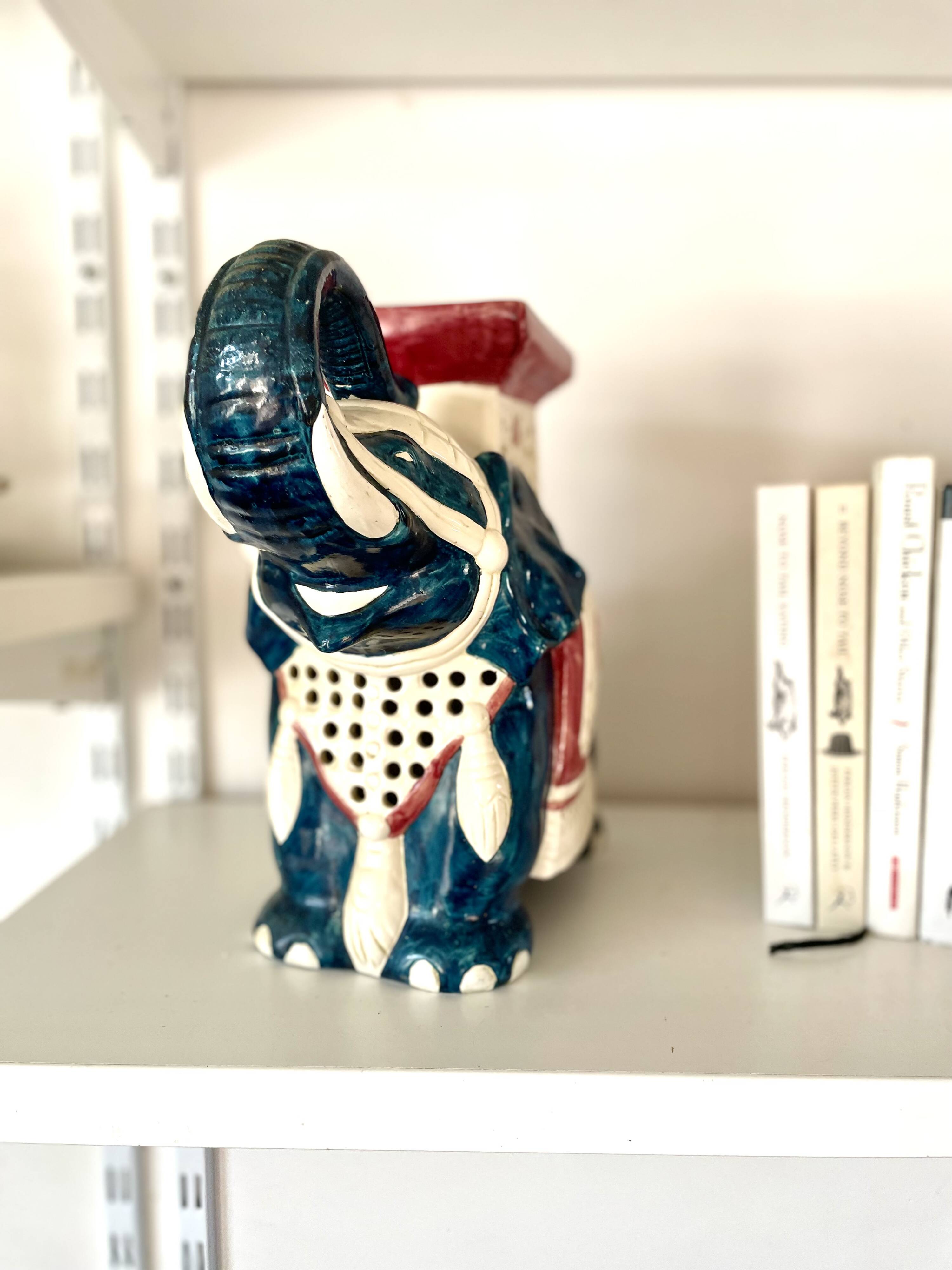 Blue and red ceramic elephant plant stand