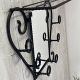 Wall-mounted coat rack with its mirror.