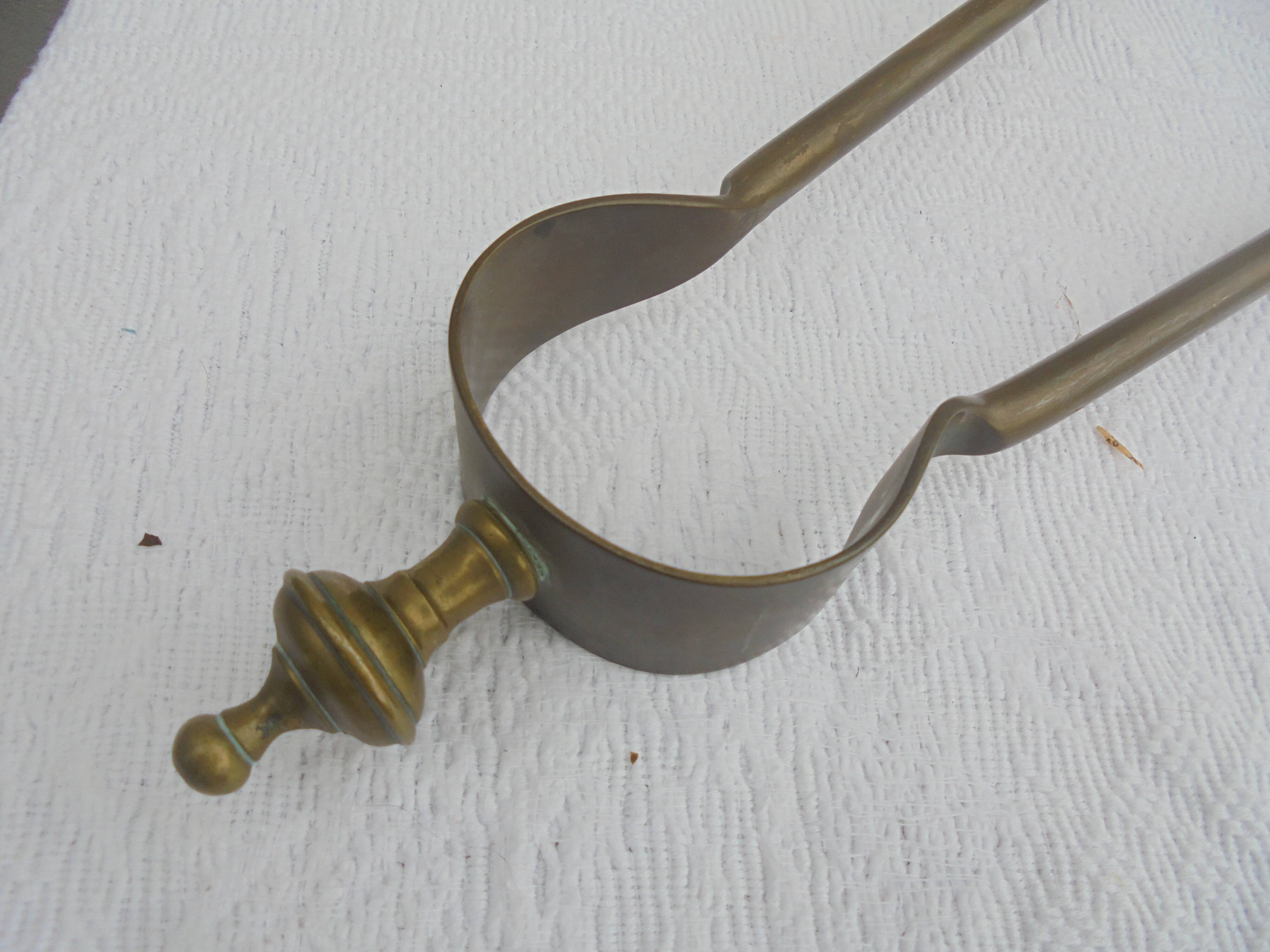 Old brass log clamp for fireplace