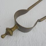 Old brass log clamp for fireplace