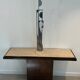 Console with a cannon-shaped travertine rifle stand. French work. Around 1970.