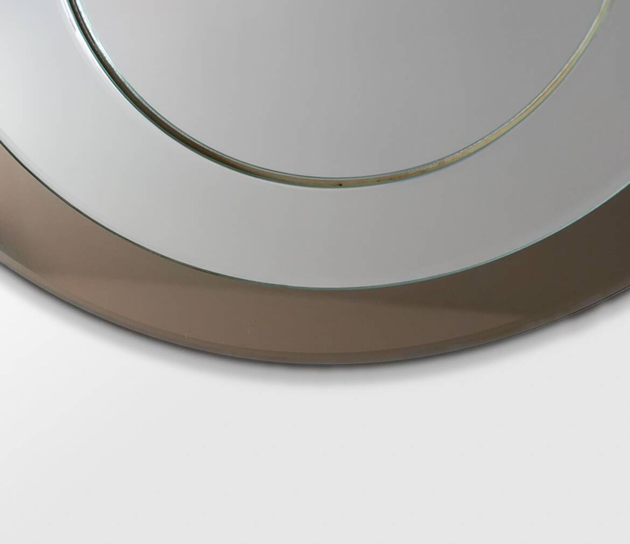 Round brown glass wall mirror attributed to Cristal Art, Italy, 1970s.