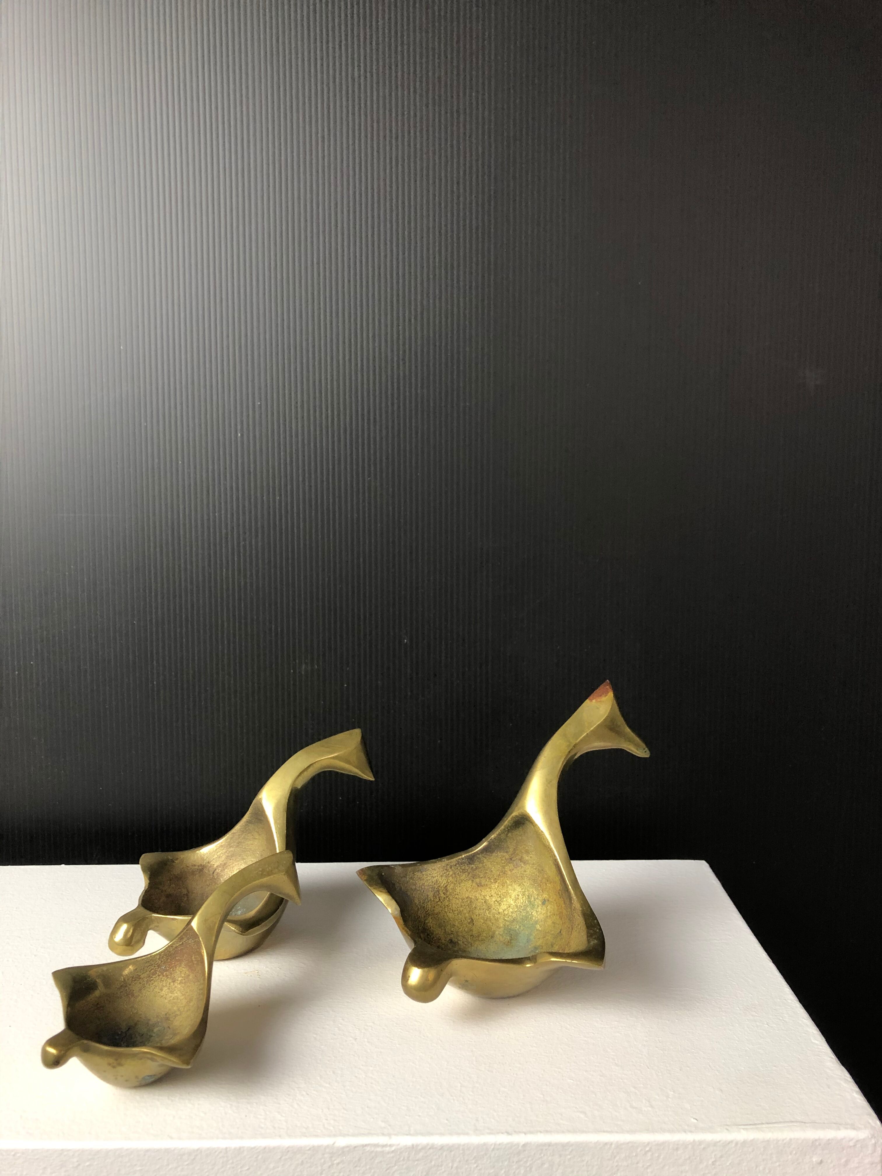 Suite of bronze "swan" ashtrays