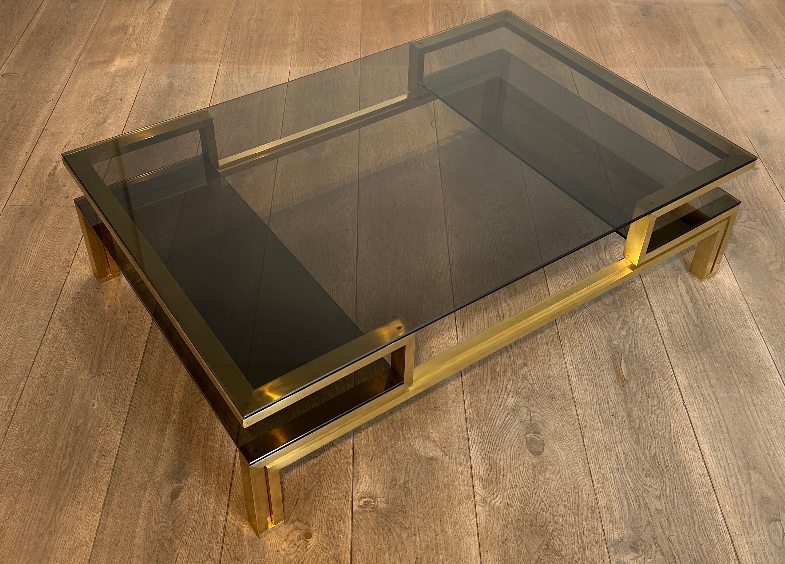 Modernist coffee table in brass and smoked glass tops by Guy Lefèvre for Maison Jansen.