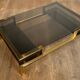 Modernist coffee table in brass and smoked glass tops by Guy Lefèvre for Maison Jansen.