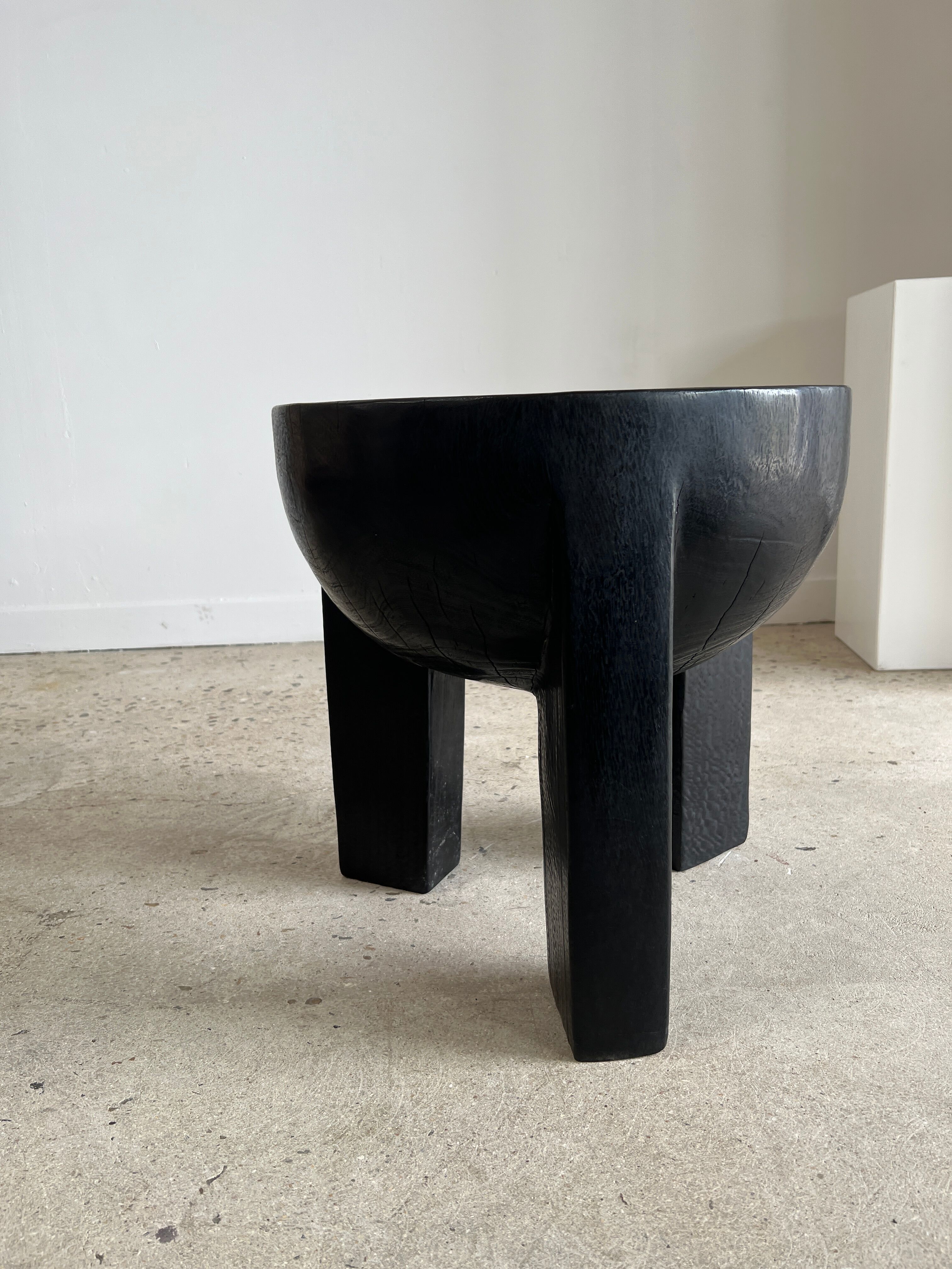 Black mango wood tripod side table with a semi-spherical top, height: 45 cm, diameter: 44 cm.