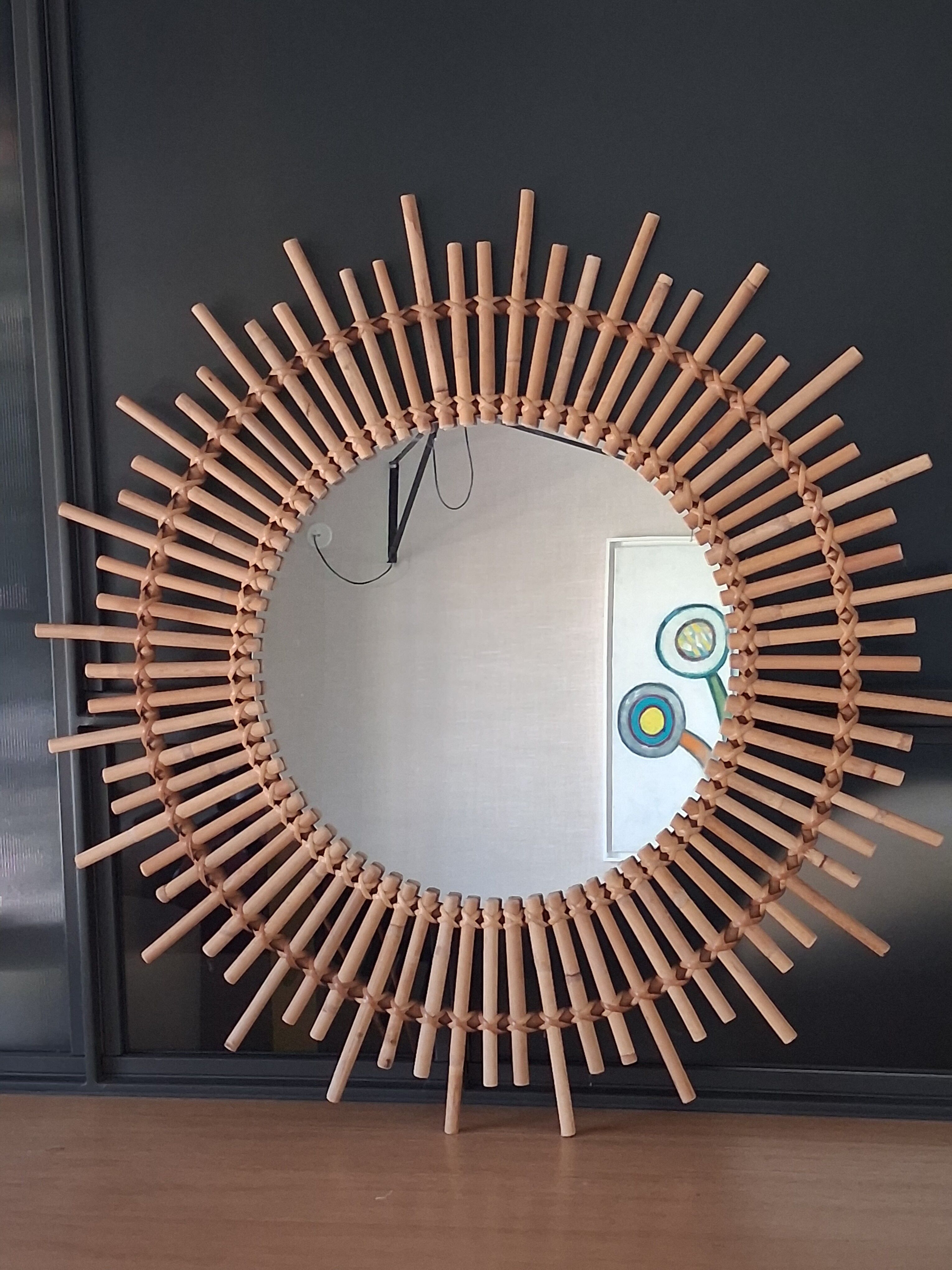 Very large sun mirror in rattan.