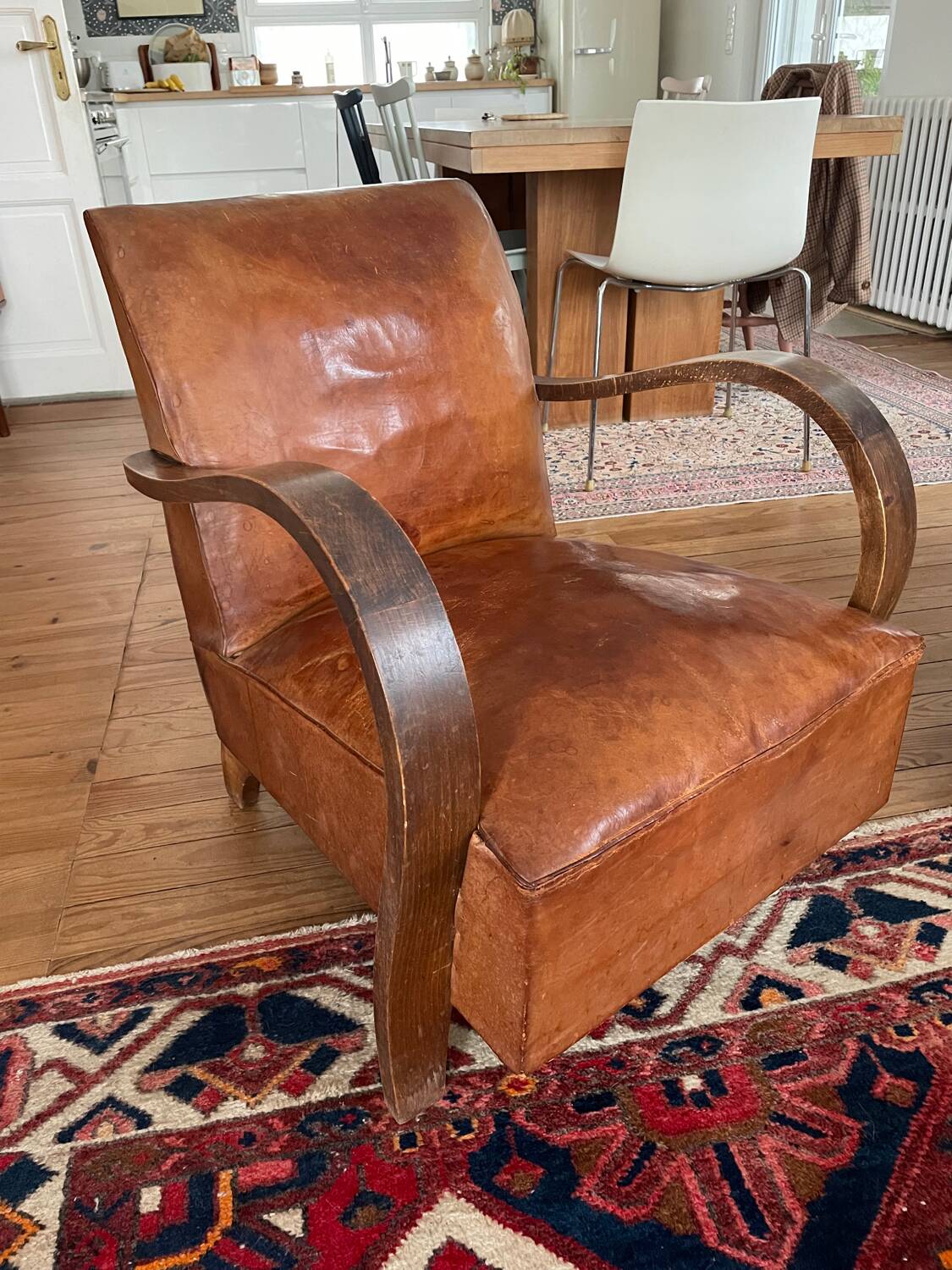Vintage leather club chair with wooden armrests