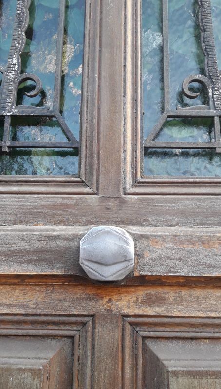 Oak entrance door and its frame and transom, wrought iron gates