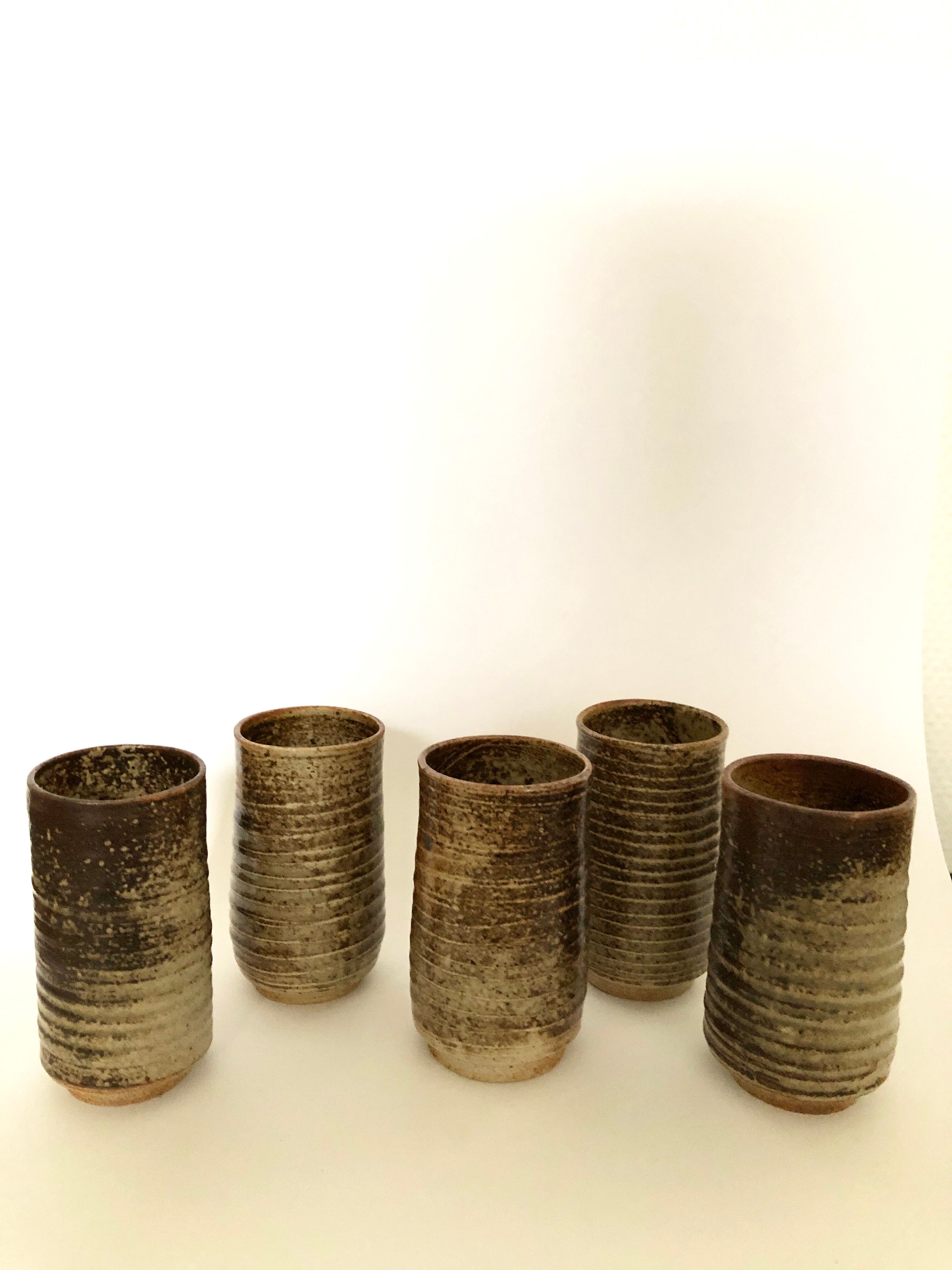 Series of five cups in sandstone