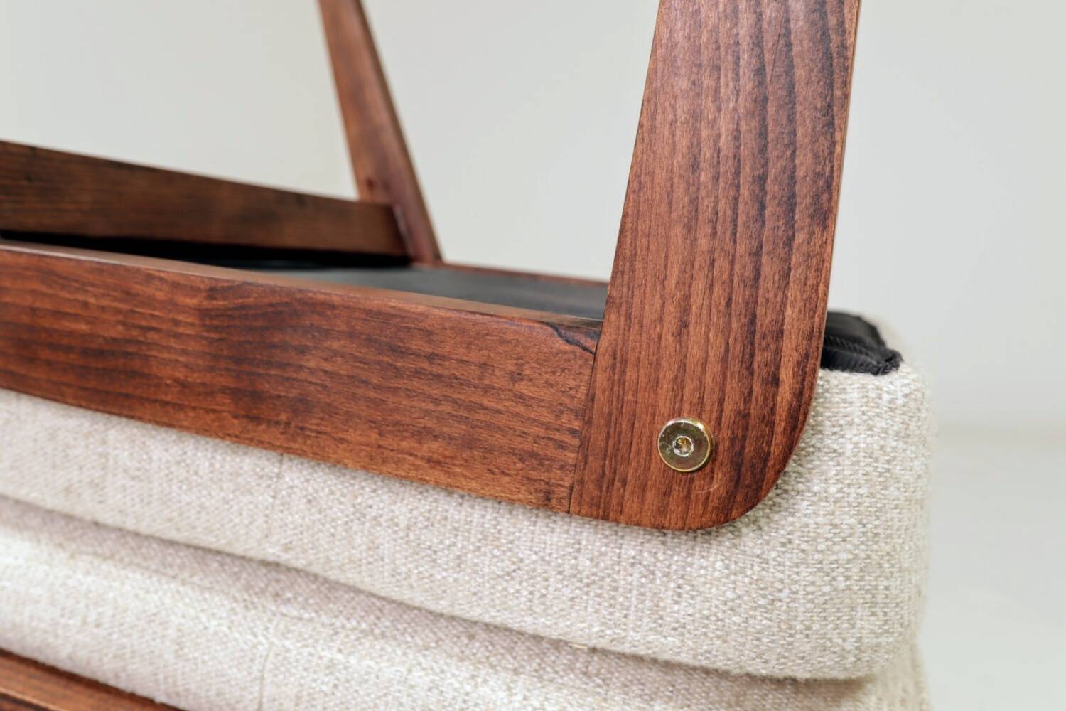 Pair of wooden stools with beige fabric.